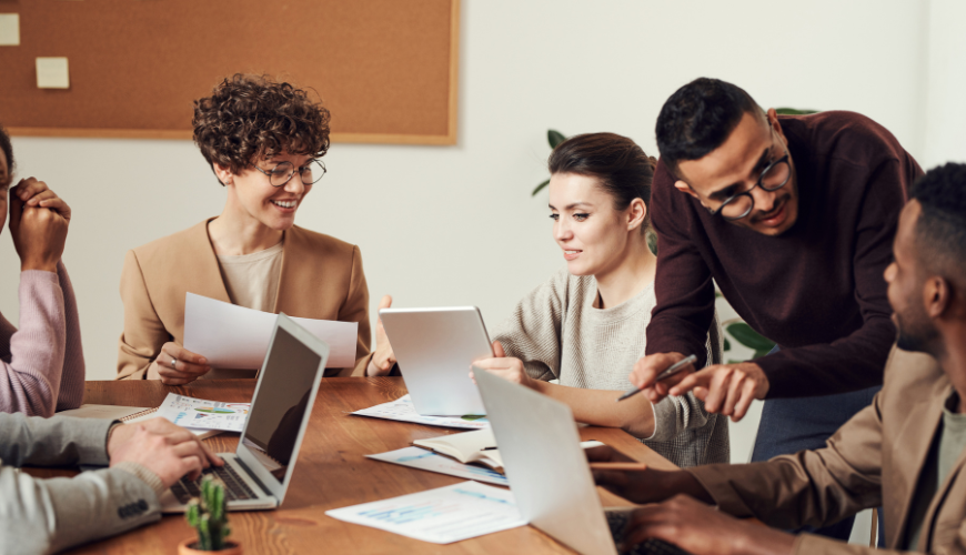 Four people in shared office working together